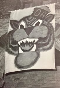 The OA Tiger banner, on Thanksgiving eve, on display against the front of Oakes Ames Memorial Hall